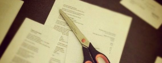 Some printed pages cut up, and a scissors